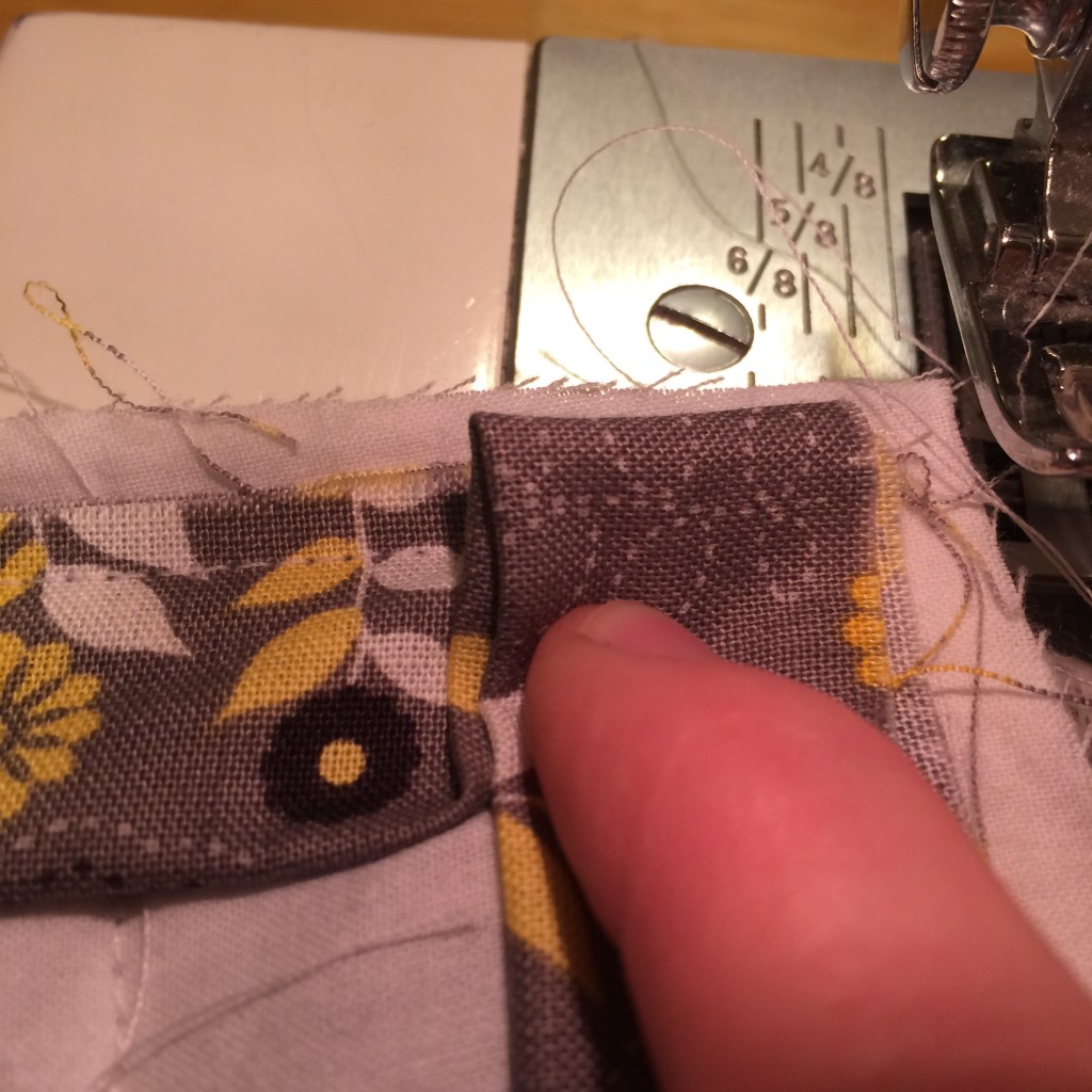 How to Sew an Ironing Pad | A Domestic Wildflower click through to read this tutorial for working with ironing board fabric and how to sew a mitered corner!